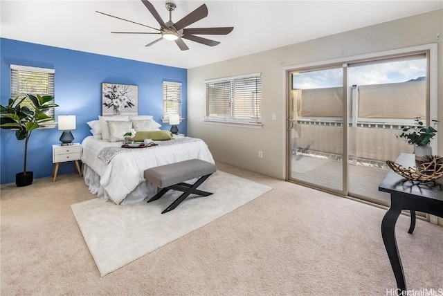 carpeted bedroom featuring access to exterior, multiple windows, and ceiling fan