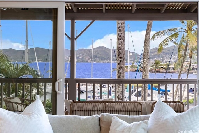 sunroom with a water and mountain view