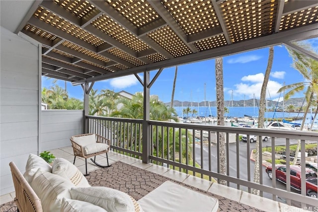 view of patio / terrace with a water view and a balcony