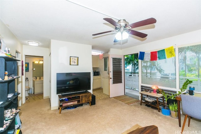 living room featuring light carpet and ceiling fan