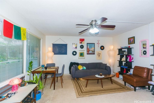 carpeted living room with ceiling fan