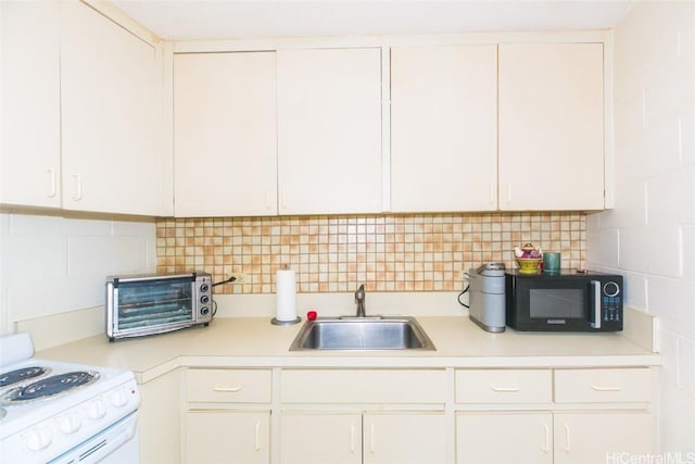 kitchen with white cabinets, white electric range oven, and sink