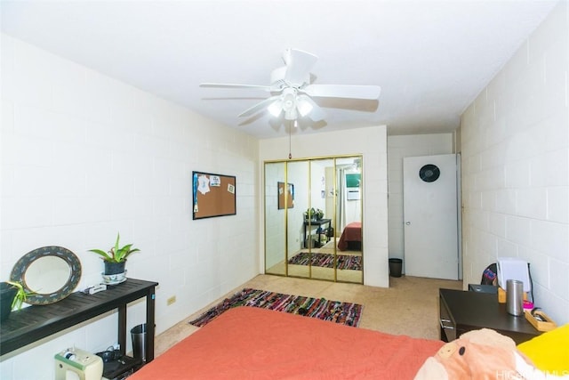 carpeted bedroom featuring a closet and ceiling fan