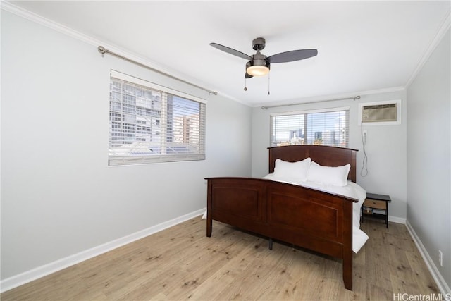 bedroom featuring crown molding, a wall unit AC, ceiling fan, and light hardwood / wood-style floors