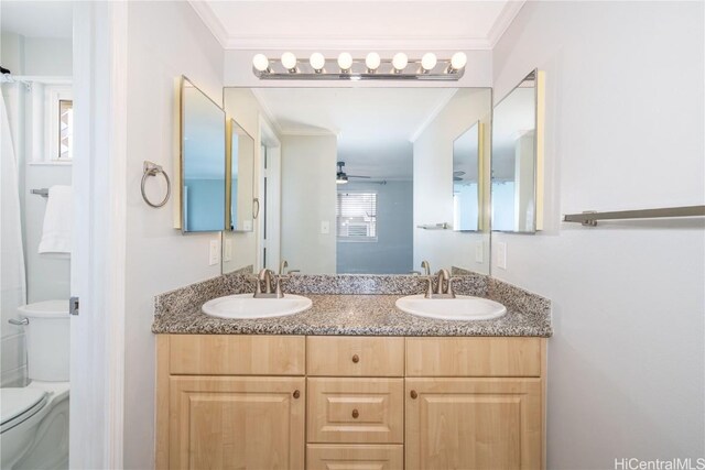 bathroom featuring vanity, ceiling fan, ornamental molding, and toilet