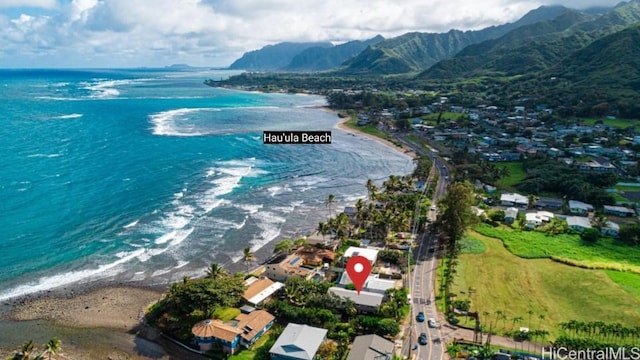 drone / aerial view featuring a water and mountain view