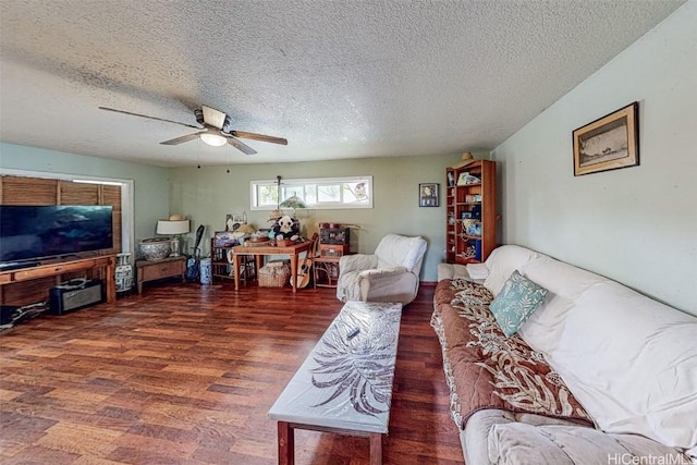 living room with ceiling fan, dark hardwood / wood-style floors, and a textured ceiling