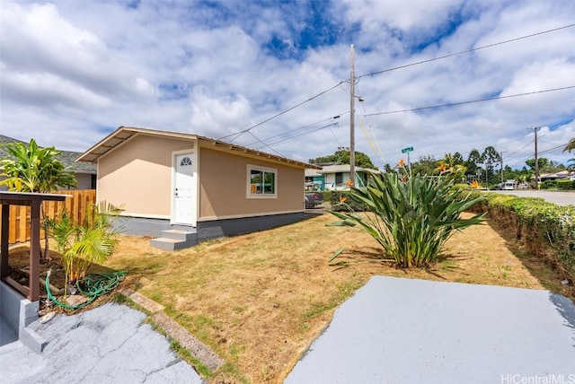 view of side of home with a lawn