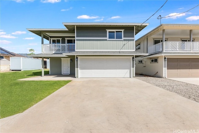 view of front of house featuring a balcony, a garage, and a front lawn