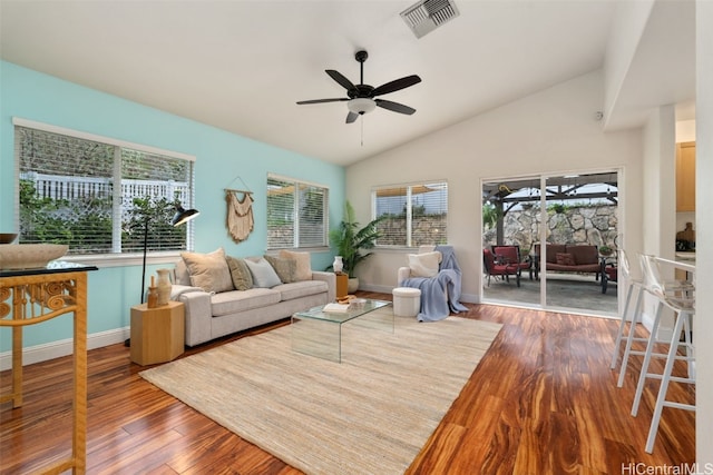 living room featuring wood-type flooring, vaulted ceiling, and ceiling fan