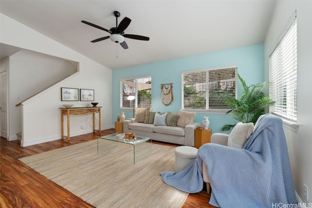 living room with ceiling fan, wood-type flooring, and vaulted ceiling