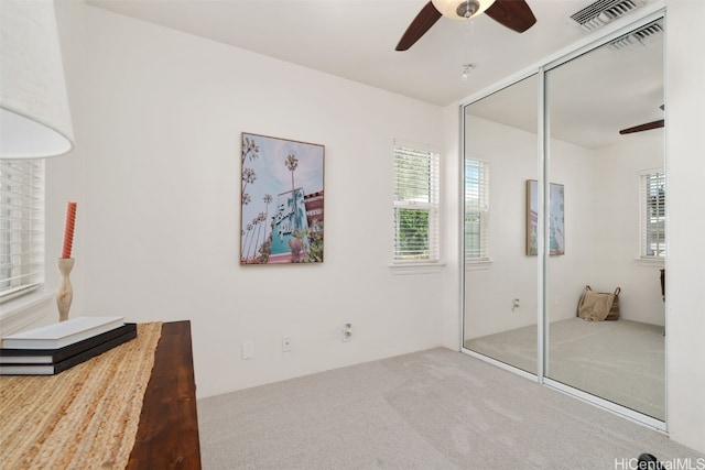 unfurnished bedroom with carpet flooring, a closet, and ceiling fan