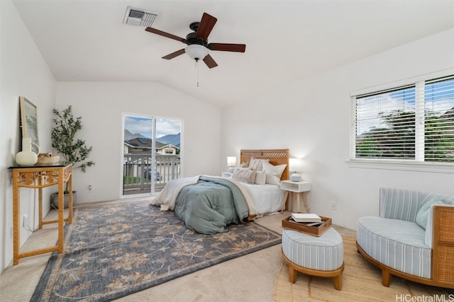 carpeted bedroom featuring access to outside, vaulted ceiling, and ceiling fan