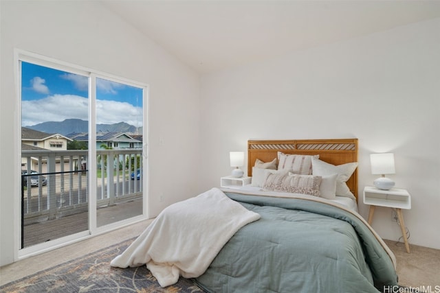 carpeted bedroom featuring access to exterior, a mountain view, vaulted ceiling, and multiple windows