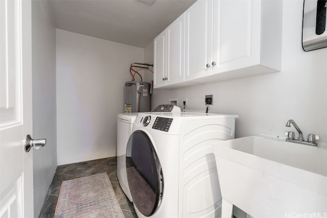 laundry room with washer and clothes dryer, water heater, sink, and cabinets