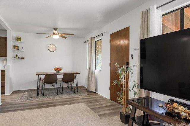 dining room with hardwood / wood-style flooring and ceiling fan