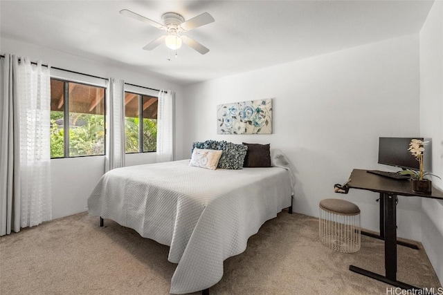 bedroom with ceiling fan and light carpet