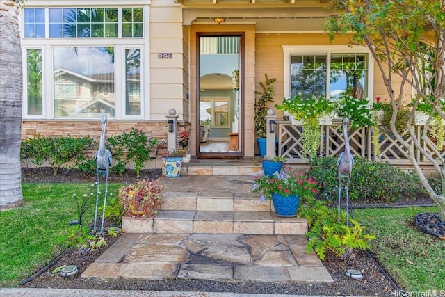 entrance to property featuring a lawn