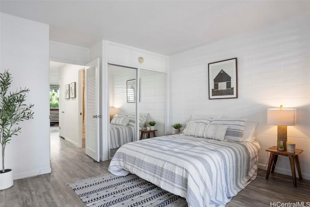 bedroom featuring hardwood / wood-style flooring and a closet