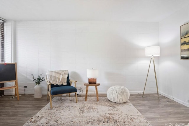 sitting room with hardwood / wood-style flooring