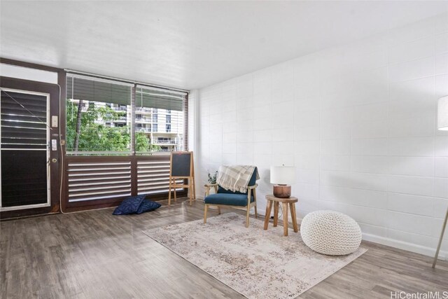 sitting room featuring hardwood / wood-style flooring and expansive windows