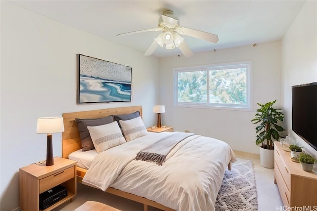 bedroom with a ceiling fan and light carpet