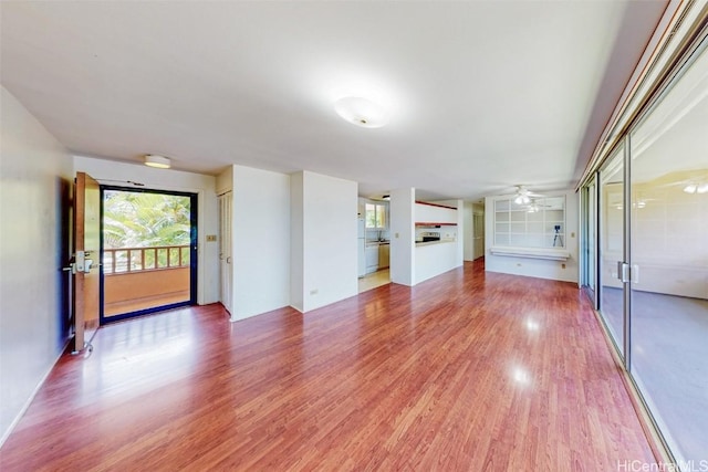 unfurnished living room featuring light wood-style floors and ceiling fan