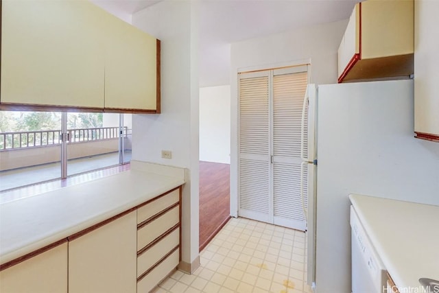 kitchen with light floors, light countertops, and freestanding refrigerator