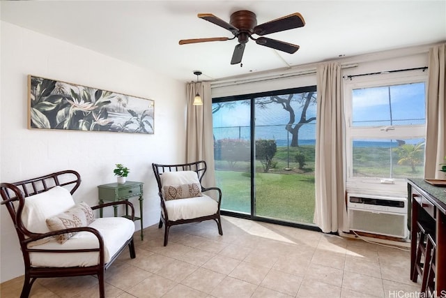 sitting room with ceiling fan, light tile patterned floors, and a wealth of natural light