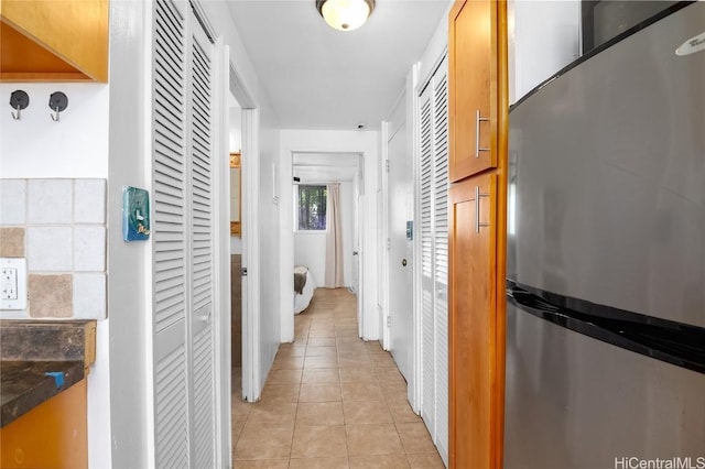 corridor with light tile patterned floors