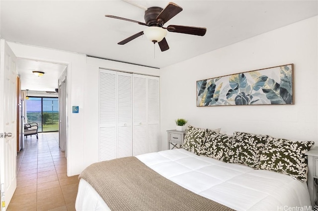 bedroom featuring light tile patterned floors, a closet, and ceiling fan