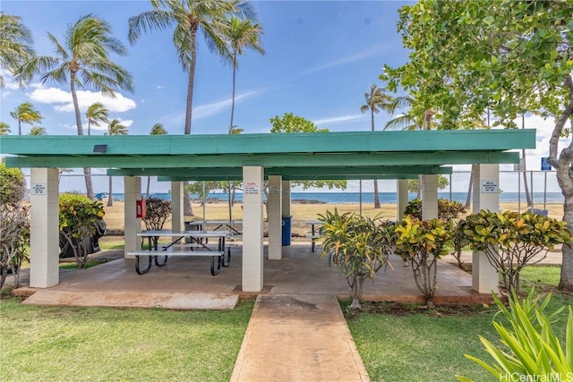 view of property's community with a water view and a yard