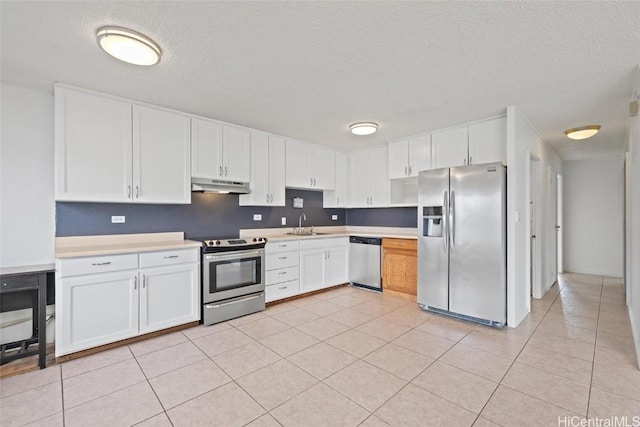 kitchen featuring white cabinets, stainless steel appliances, light tile patterned flooring, and sink