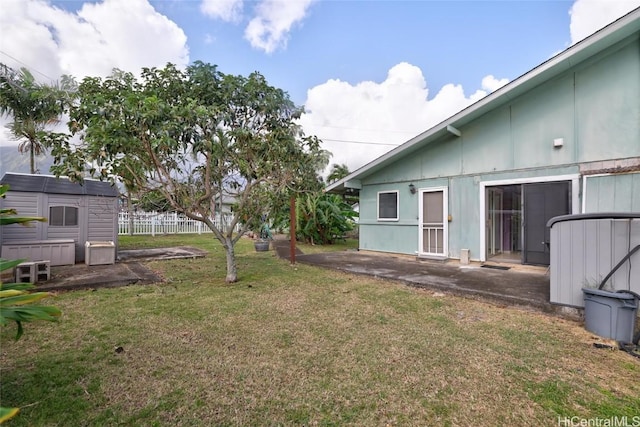 view of yard with a patio and a storage shed