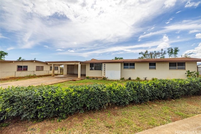 ranch-style house featuring a carport