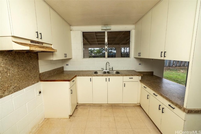 kitchen featuring sink and white cabinets