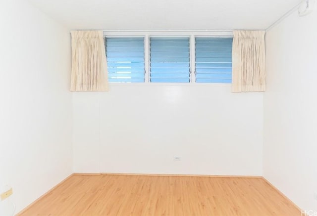 spare room with wood finished floors