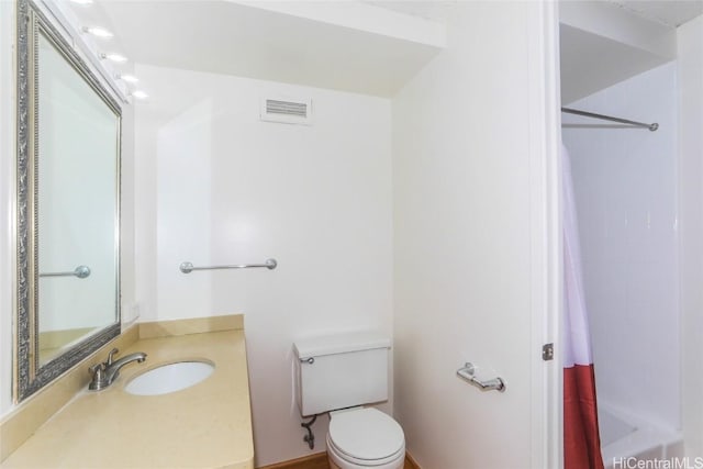 full bathroom with toilet, vanity, and visible vents