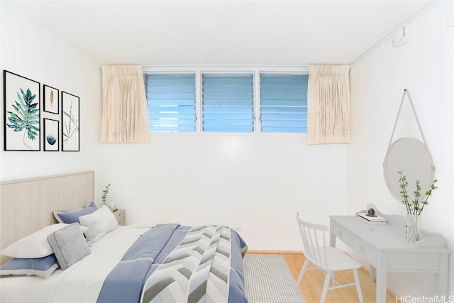 bedroom featuring wood finished floors