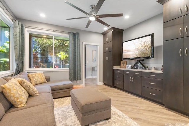 living room with light wood-type flooring and ceiling fan