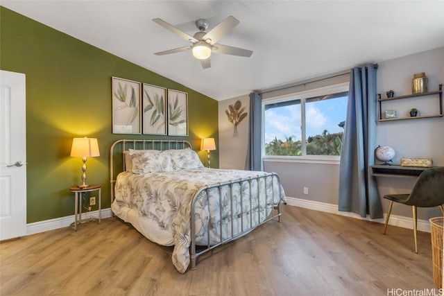 bedroom featuring ceiling fan, light hardwood / wood-style floors, and vaulted ceiling