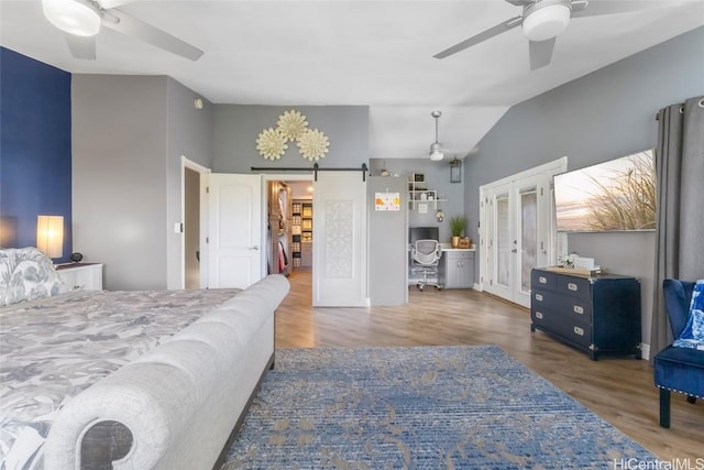 bedroom with ceiling fan, hardwood / wood-style flooring, lofted ceiling, and french doors