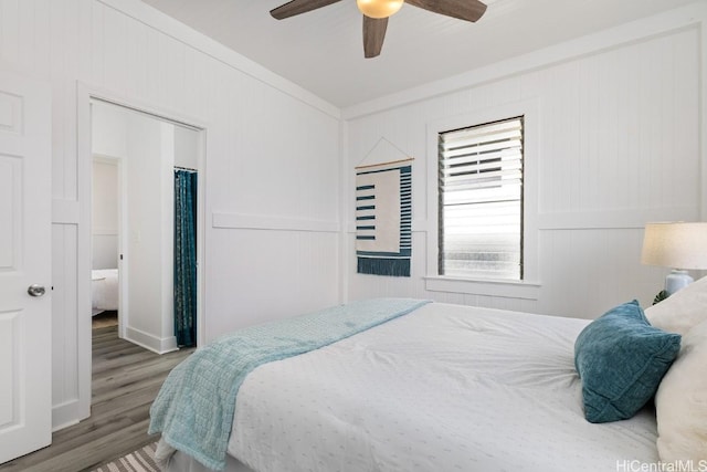 bedroom with ceiling fan, hardwood / wood-style floors, and ornamental molding