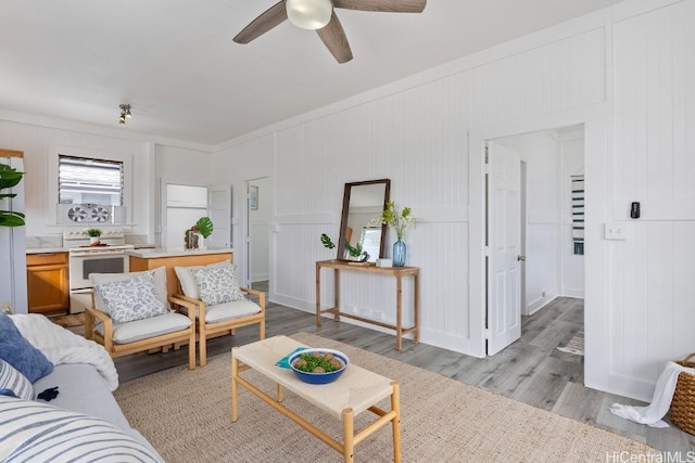 living room with ceiling fan and light hardwood / wood-style floors