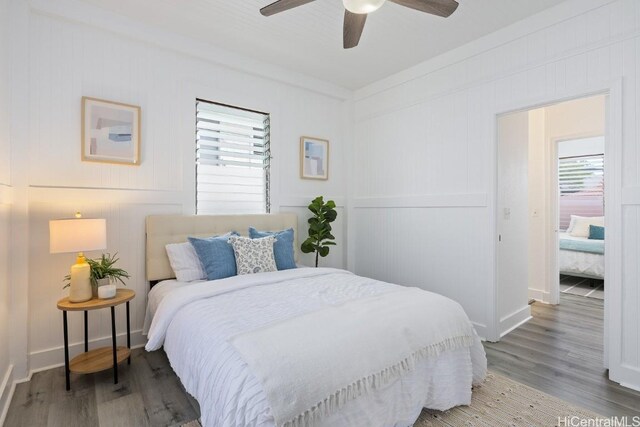 bedroom featuring baseboards, a ceiling fan, and light wood finished floors