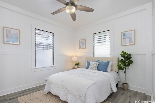 bedroom with baseboards, a ceiling fan, and wood finished floors