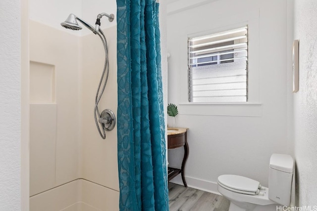 bathroom featuring hardwood / wood-style floors, toilet, radiator heating unit, and walk in shower