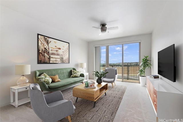 carpeted living room with ceiling fan