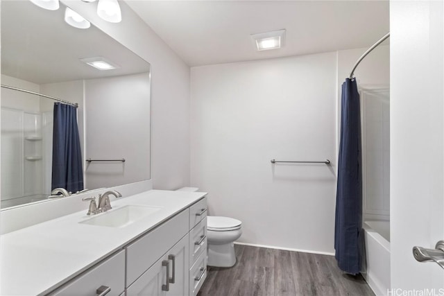 full bathroom with vanity, hardwood / wood-style floors, shower / bath combo, and toilet