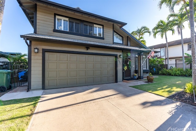 view of front of property with a front yard and a garage